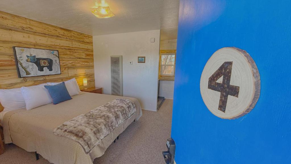 a bedroom with a bed and a cross on the wall at King Bear Mokee Pets OK, Shared Kitchen! #4 in Bluff