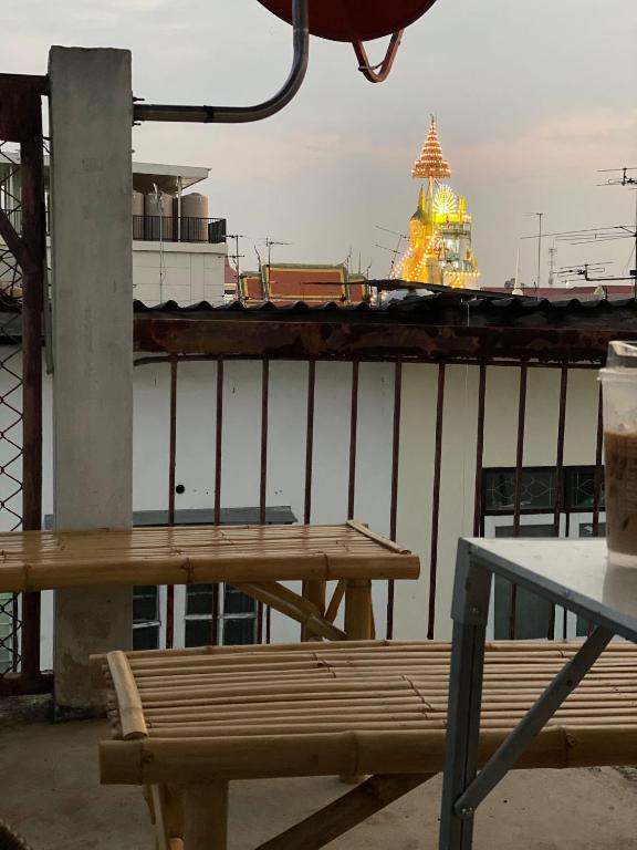 two picnic tables on a balcony with a cruise ship at PAMA'Pranakorn in Bangkok