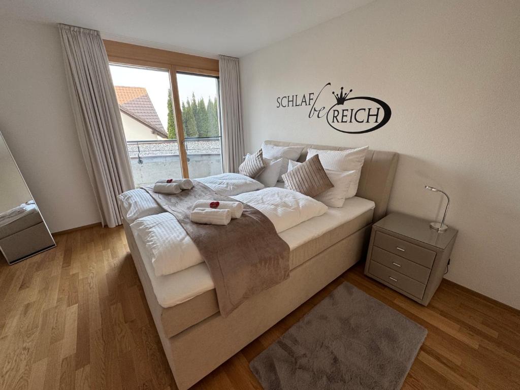 a bedroom with a bed and a window at Arenenberg-Panorama in Salenstein
