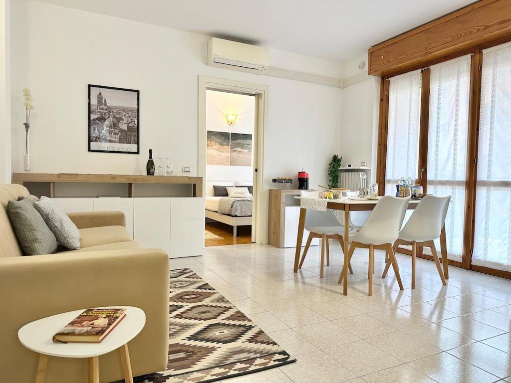 a living room with a couch and a table at La casa di AngeLis in Stezzano