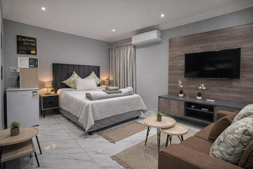 a hotel room with a bed and a flat screen tv at Miaz Palace in Elim