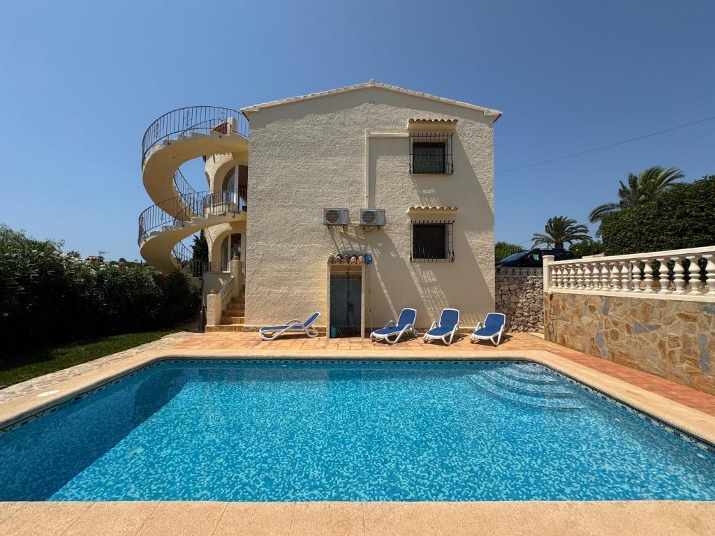 a villa with a swimming pool in front of a house at Casa Luis - Javea - Spanien in Jávea