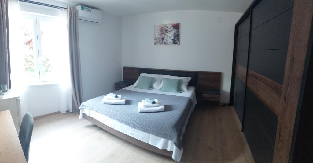 a bedroom with a bed with two towels on it at Room Depikolo 2 in Krk