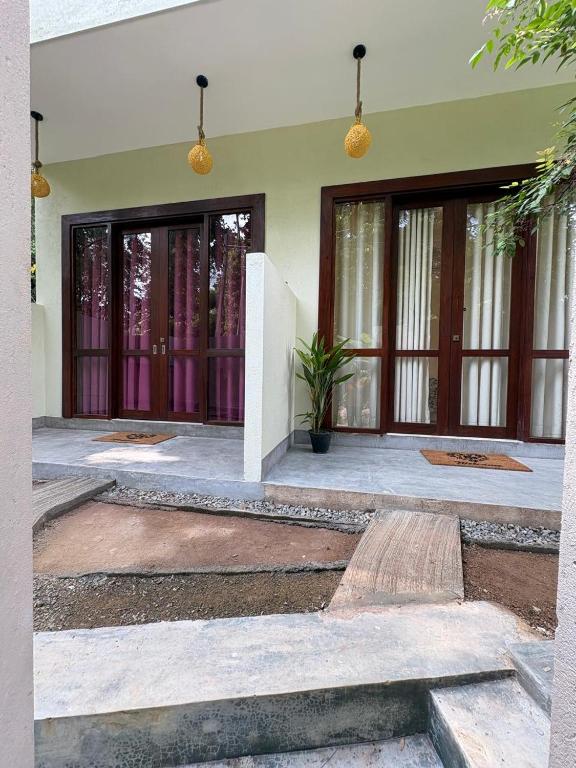 a house with two doors and a courtyard at Teyra Lodge in Galle