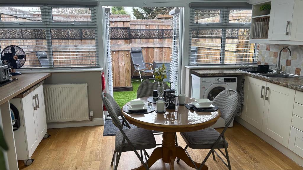 a kitchen with a table and chairs in a room at Berrow Breeze in Burnham on Sea