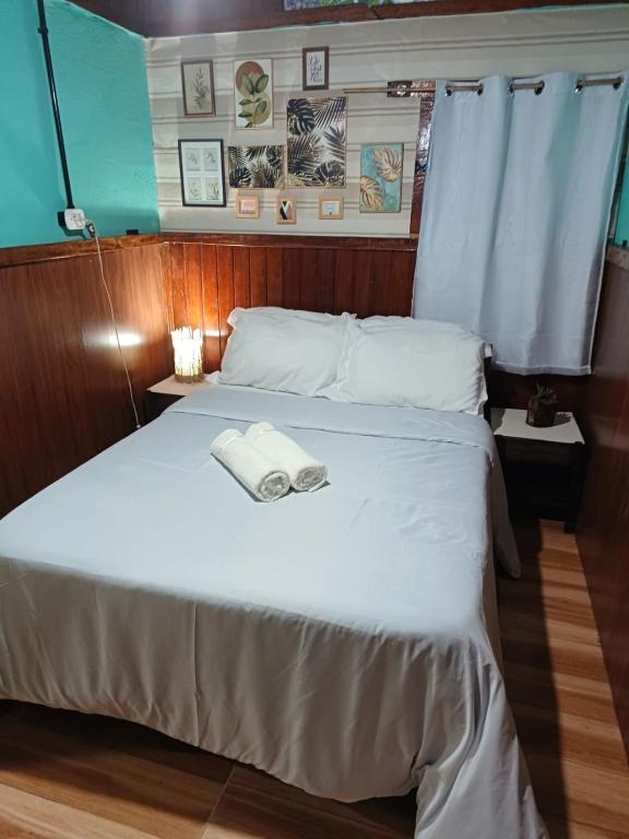 a bedroom with a bed with a towel on it at Pousada Oliveira Ramos in Lumiar