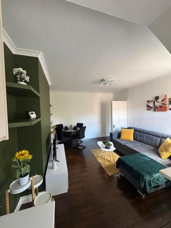 a living room with a couch and a table at Spacious 3BR Flat near Newcastle Centre in Saint Peters