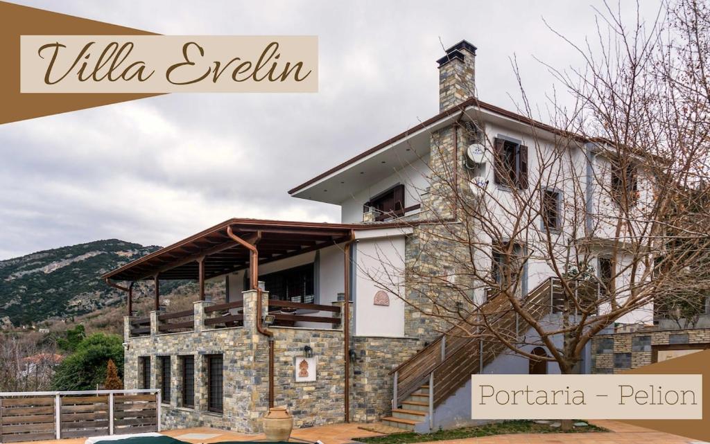 a house in the mountains with the words villa evulin at Evelin Apartment in Portaria