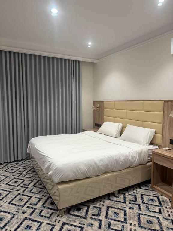 a bedroom with a large white bed in it at Dar Al-Areed in Medina