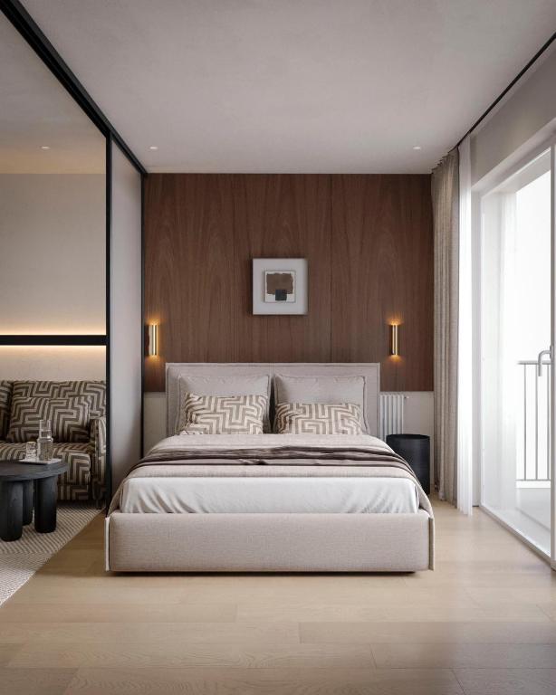 a bedroom with a large white bed and wooden walls at Apart-hotel Centr in Sumy