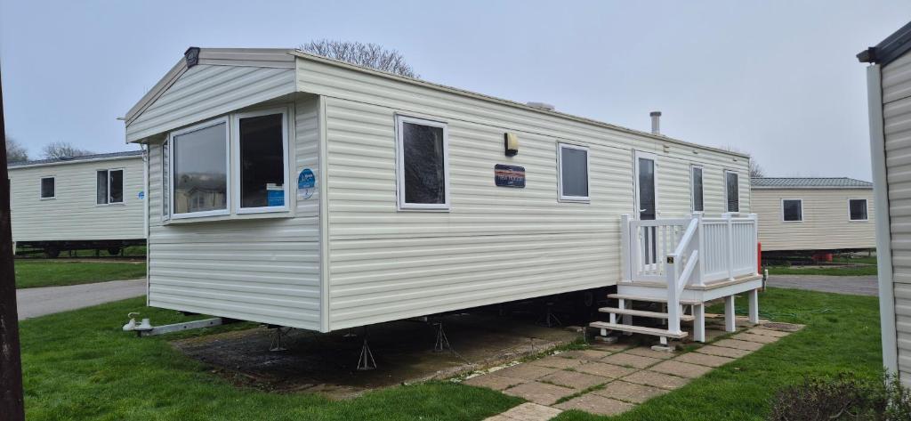 a gray and white tiny house in a yard at Caravan J&L Weymouth Bay in Weymouth
