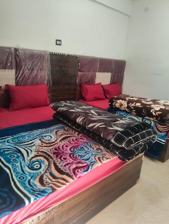 two beds sitting next to each other in a room at Balaji hotel in Badrinath