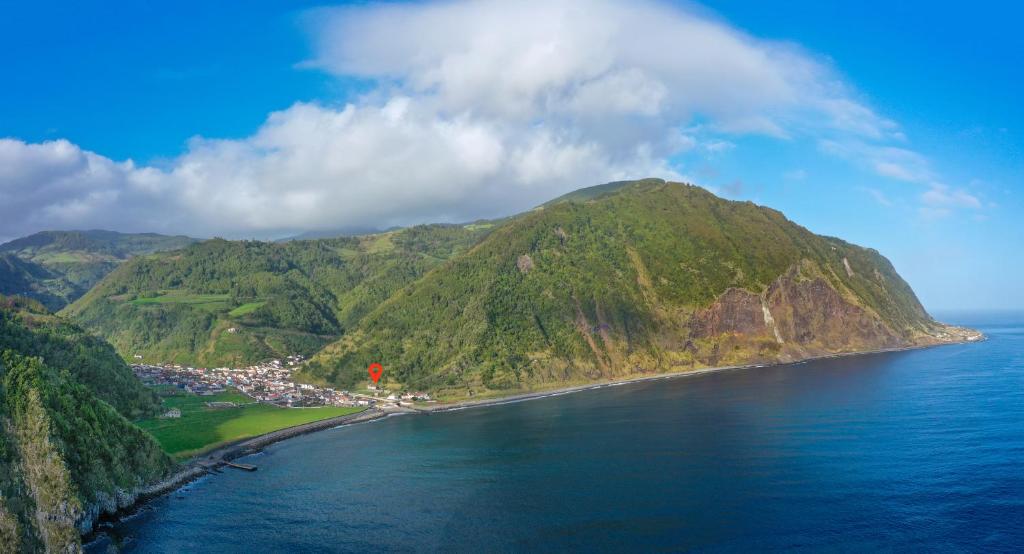 an aerial view of a small island in the ocean at Entre a Pedra e o Mar in Faial da Terra