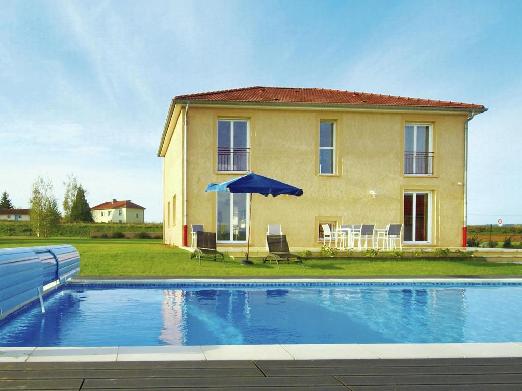 a house with a swimming pool in front of a house at Cosy vacation home near the sea in Verdun