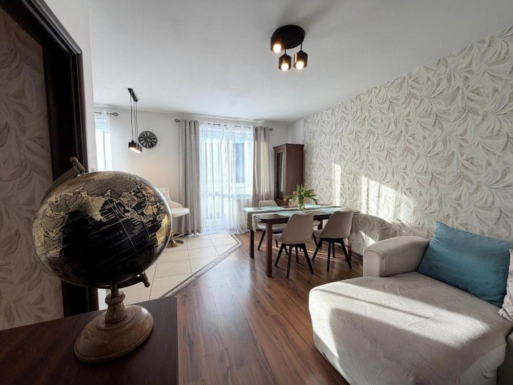 a living room with a white couch and a table at Gustowny apartament in Inowrocław