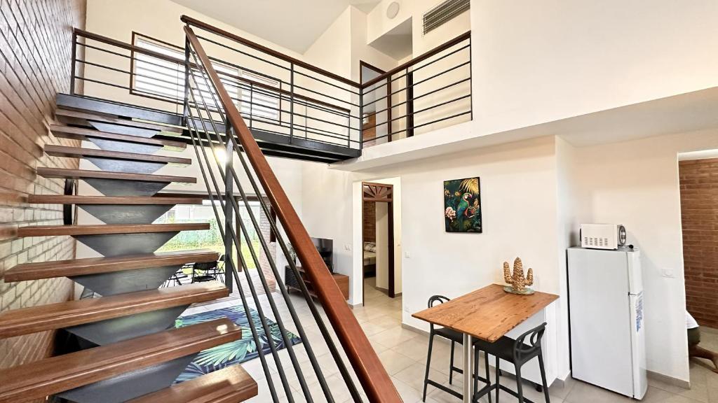 a staircase in a house with a table and a kitchen at Rio - Destination Guyane in Macouria
