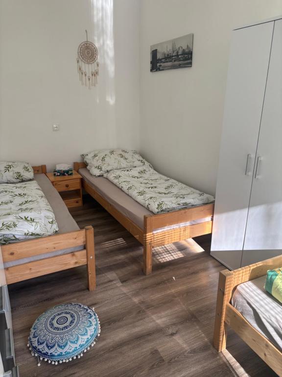 a room with two beds and a rug on the floor at Ubytování Linda in Klášter Hradiště nad Jizerou