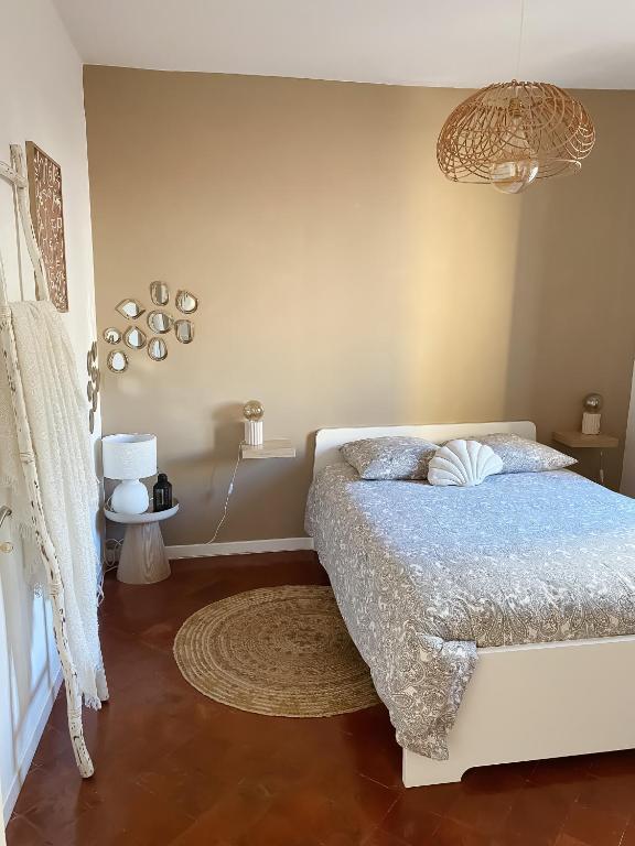 a bedroom with a bed with a blue comforter at -La Casa d'Avignon- in Avignon