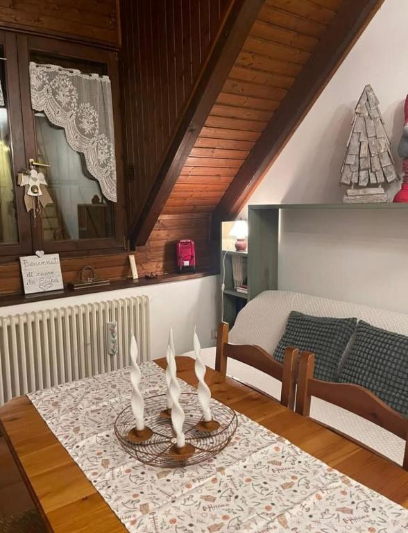 a dining room with a table and a bed at Erika in Tarvisio