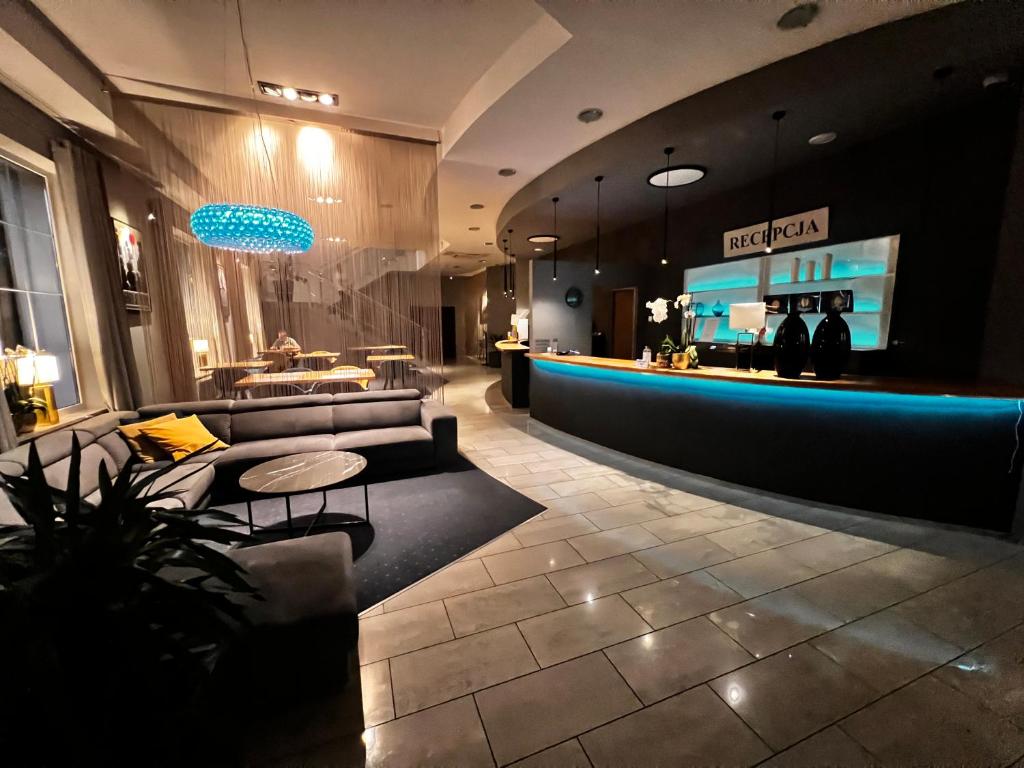 a store lobby with a couch and a bar at Hotel Nowy Dwór in Trzebnica