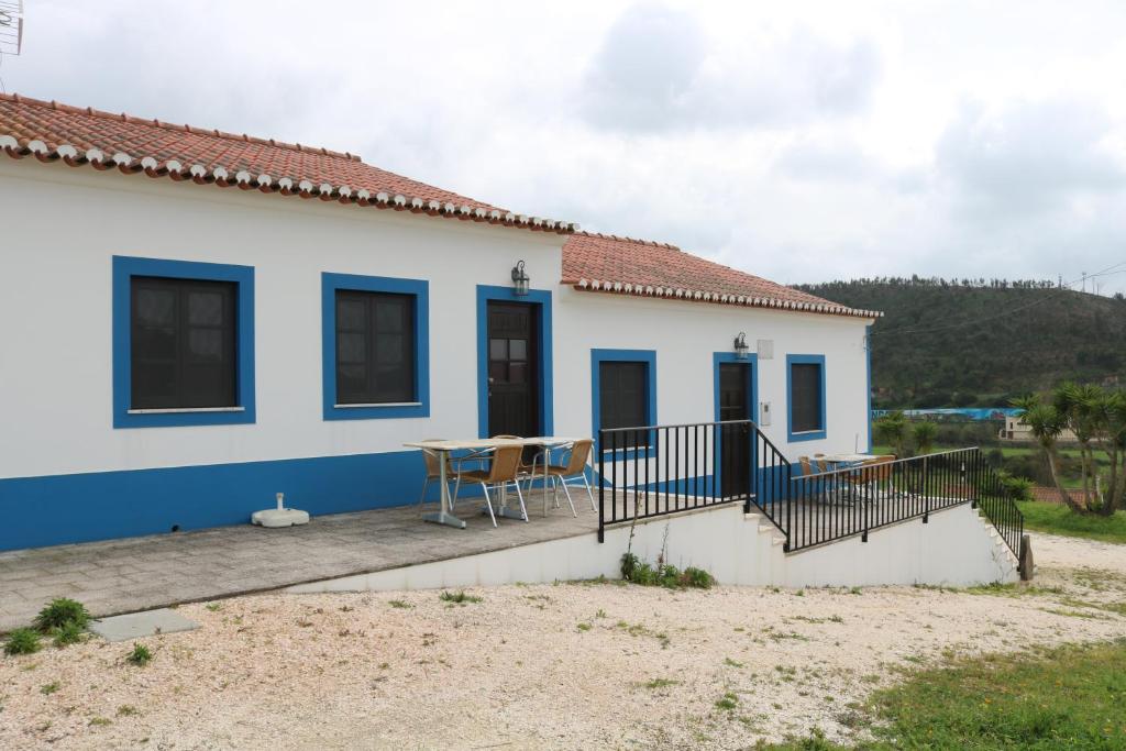 a house on the beach with a table and chairs at Montes da Barca in Aldeia Nova do Concelho