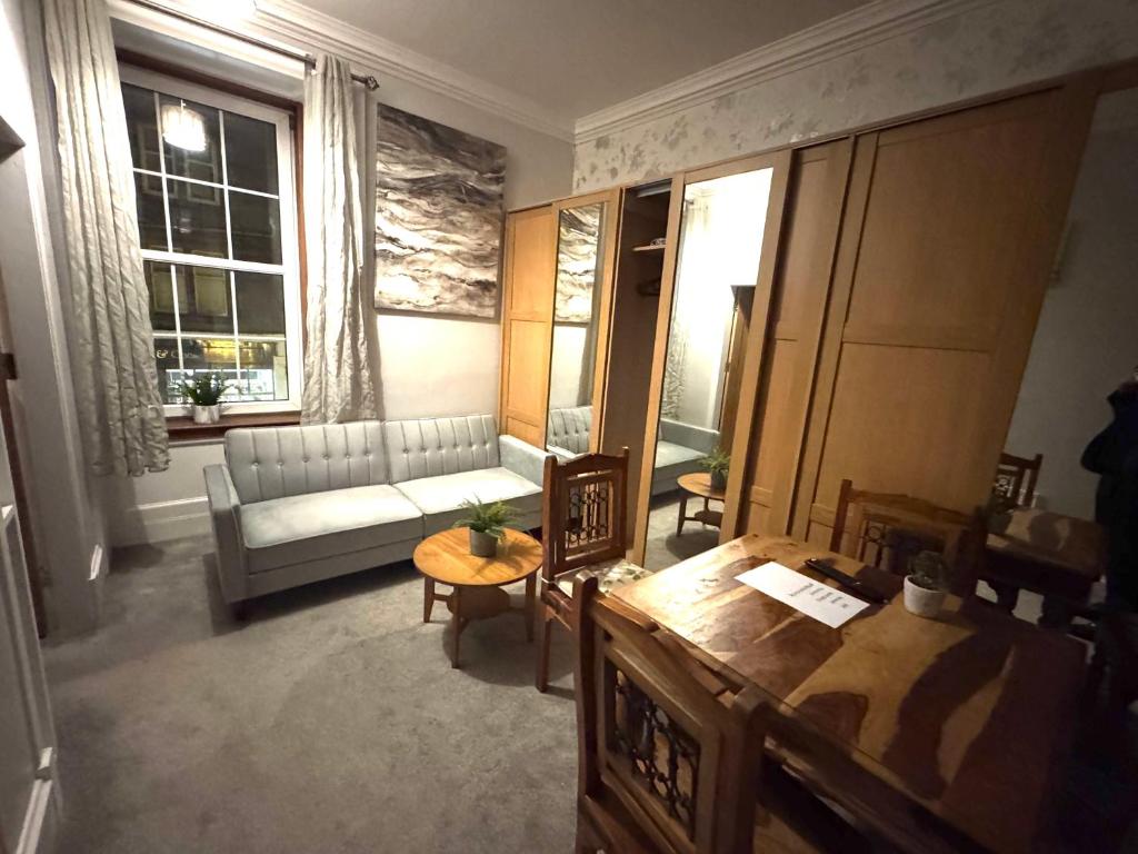a living room with a couch and a table at Meze hotel in Perth