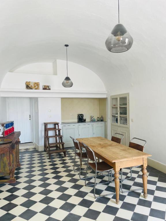 a kitchen with a table and chairs in a room at Cosmogama House in Évora