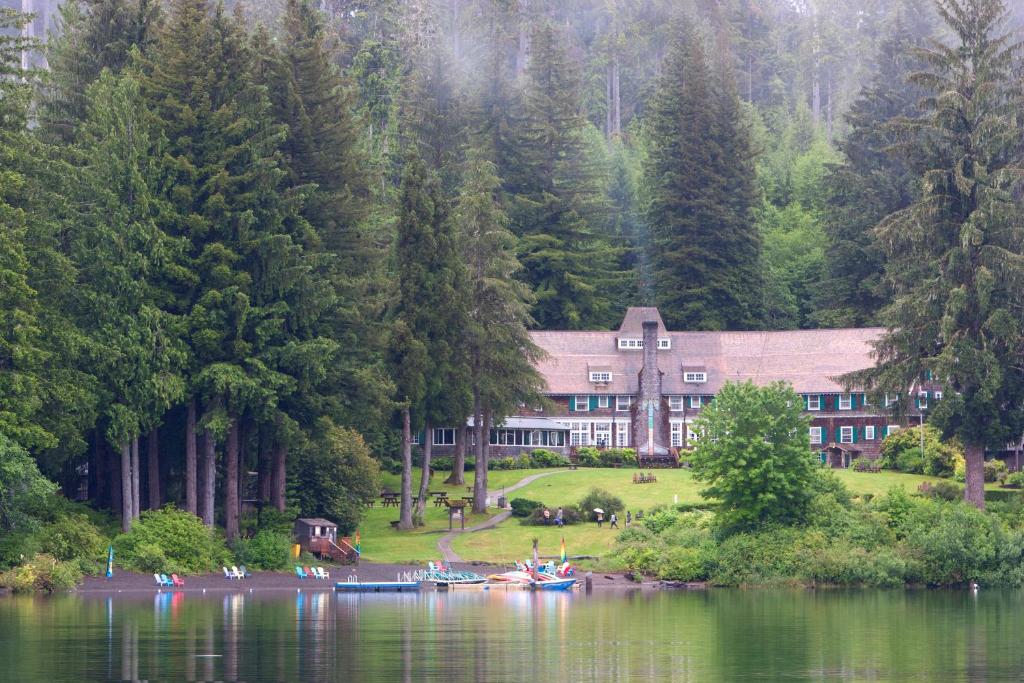 ein Haus am Ufer eines Sees mit Bäumen in der Unterkunft Lake Quinault Lodge in Quinault