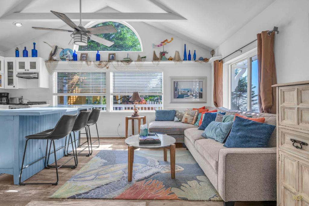 a living room with a couch and a kitchen at Rememberance in Depoe Bay