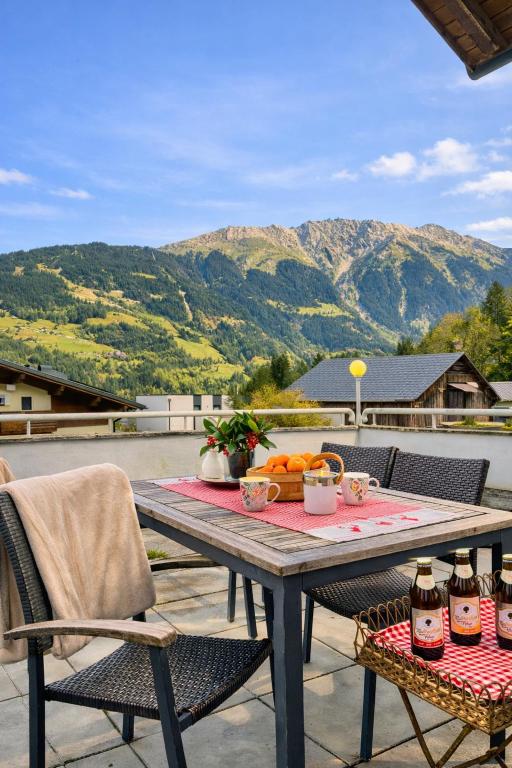 a picnic table with food on top of a patio at Haus Bergharmonie in Tschagguns