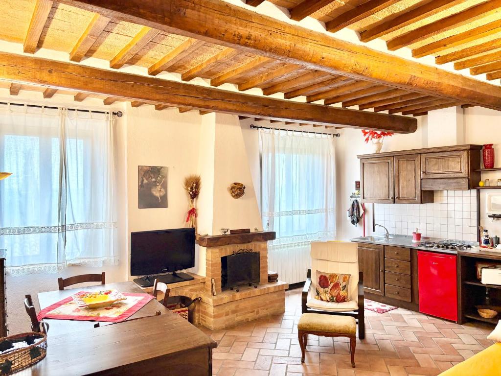 a living room with a table and a fireplace at Cor Magis in San Quirico dʼOrcia