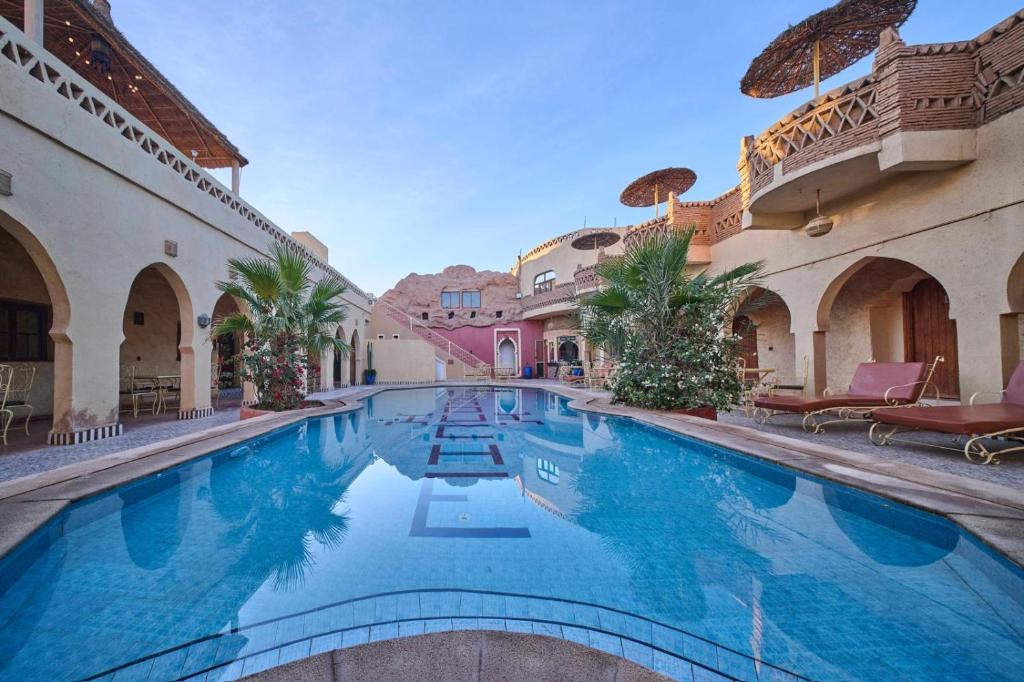 a swimming pool in the middle of a building at kasbah boutique mamouche in Adrouine