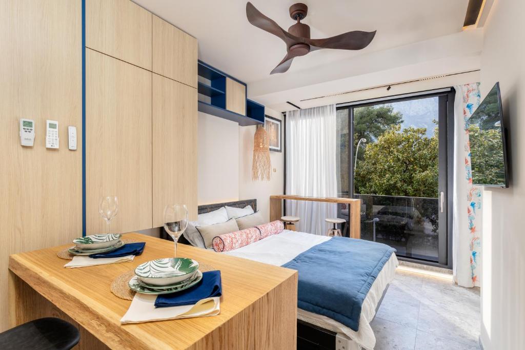 a bedroom with a bed and a table and a window at Chill out Spa Studio in Kotor