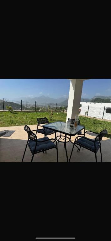 a table and two chairs and a table and a table and chairs at Bela Bar in Pečurice