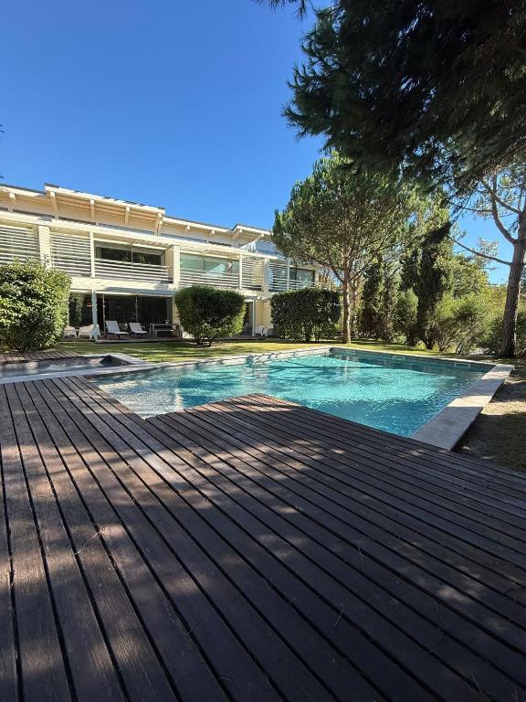 a swimming pool in front of a building at Tróia Oasis Villa in Troia