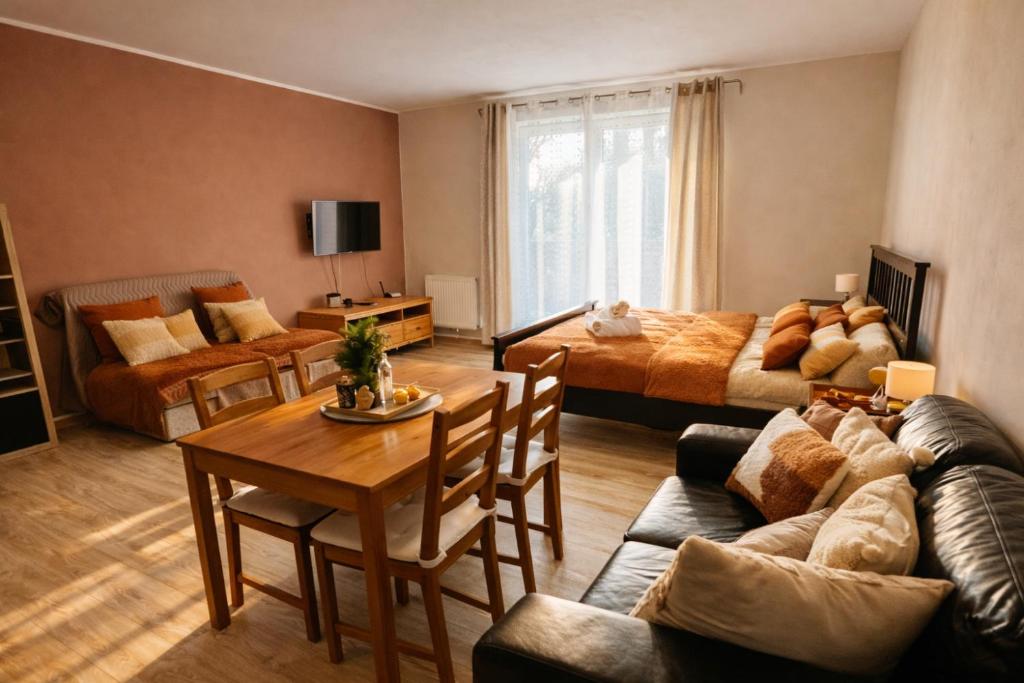 a living room with a couch and a table at Apartment Riviera 13 Lipno in Lipno nad Vltavou