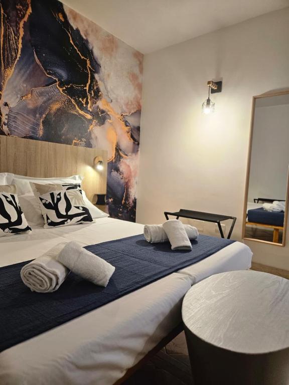 a bedroom with a large bed with towels on it at Due Passi dal Gate in Salerno Airport - Aeroporto di Salerno