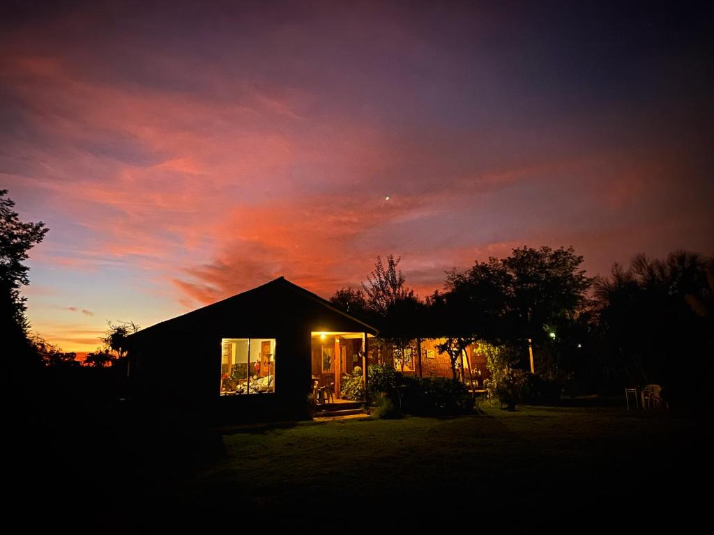 a house with a sunset in the background at La Casa Vinilla in Casablanca