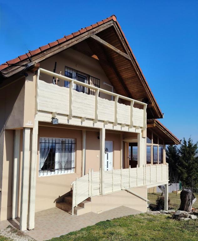a house with a porch and a balcony at Lagom Vendégház in Zalaszentgrót