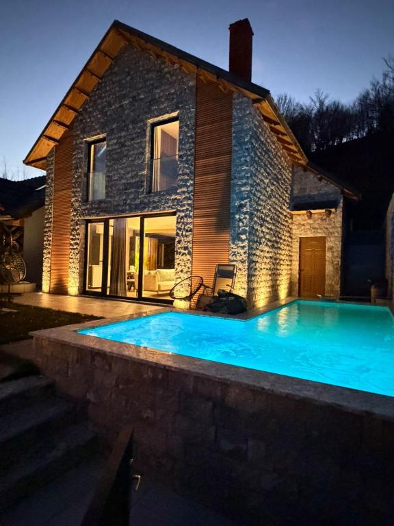 a large swimming pool in front of a house at N'Gen Luxury Villas - Razem in Razëm
