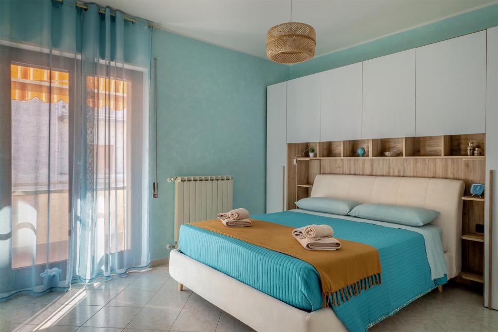 a bedroom with a bed with towels on it at Perla del Salento in Brindisi