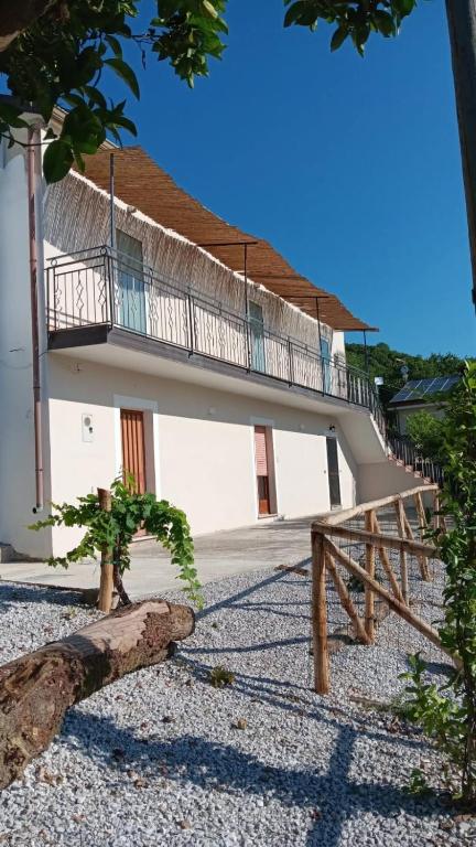 a building with a balcony on top of it at Affittacamere Nonna Ia in Lustra