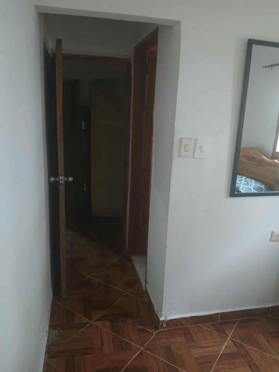 an empty room with a mirror and a door at Casa madrigueña rincón del mar in Rincón