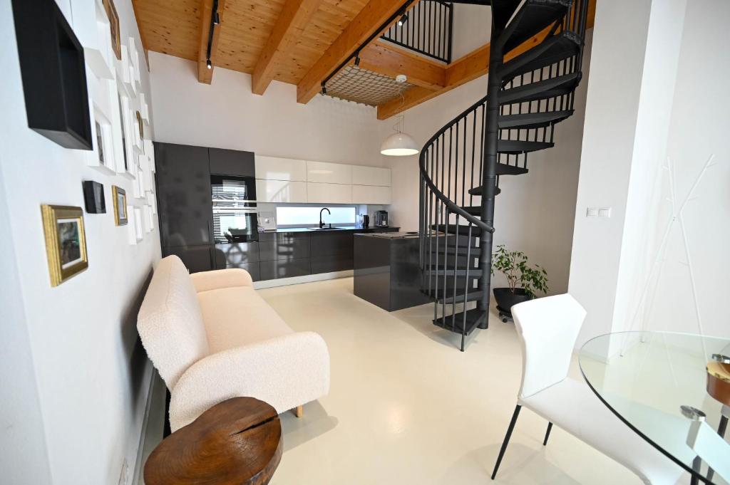 a living room with a staircase and a glass table at Villa OLIVA in Kľačany