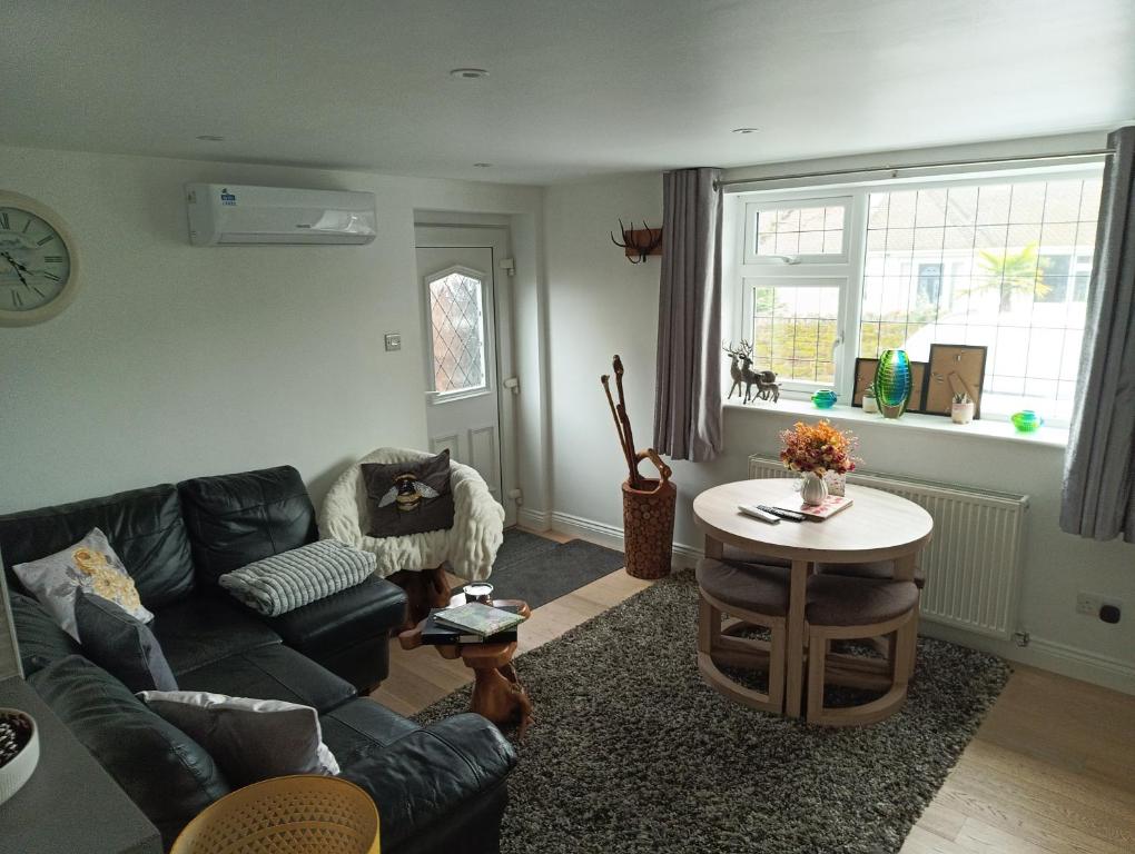 a living room with a couch and a table at The Travellers Retreat in Neston