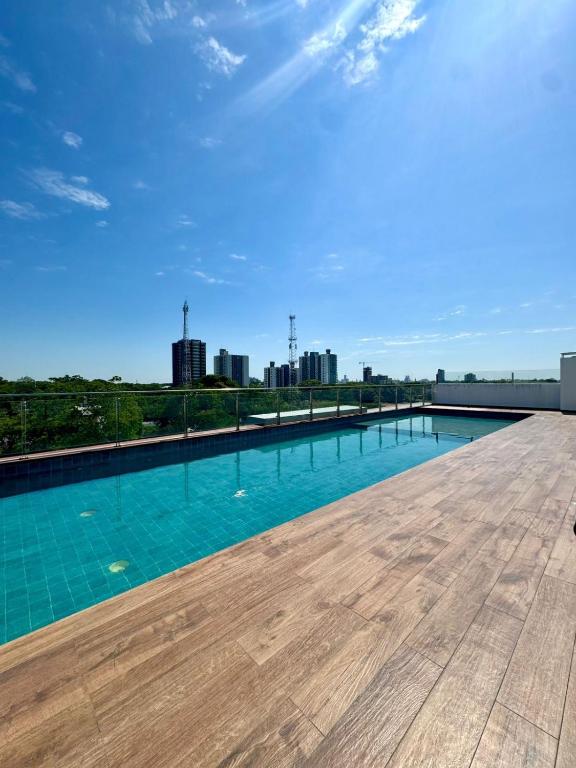 a swimming pool with a city skyline in the background at Departamento completo en zona Turística de Santa Cruz in Santa Cruz de la Sierra