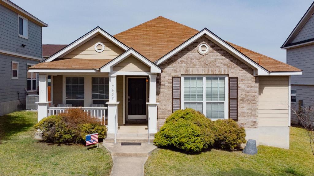 a house with a front door and a yard at Modern Updates - Great Location - King Bed- BMT in San Antonio