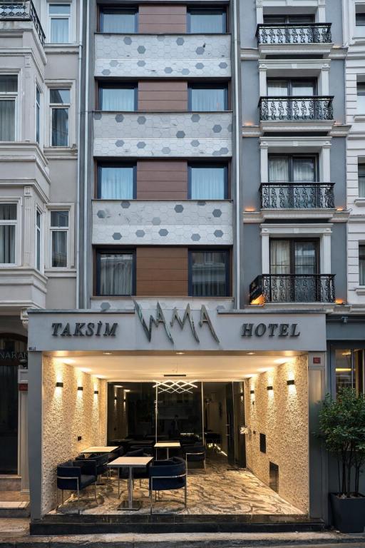 a hotel with tables and chairs in front of it at VAMA TAKSİM Hotel in Istanbul