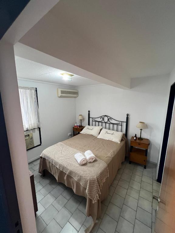 a bedroom with a bed with two towels on it at Corro 8 in Córdoba