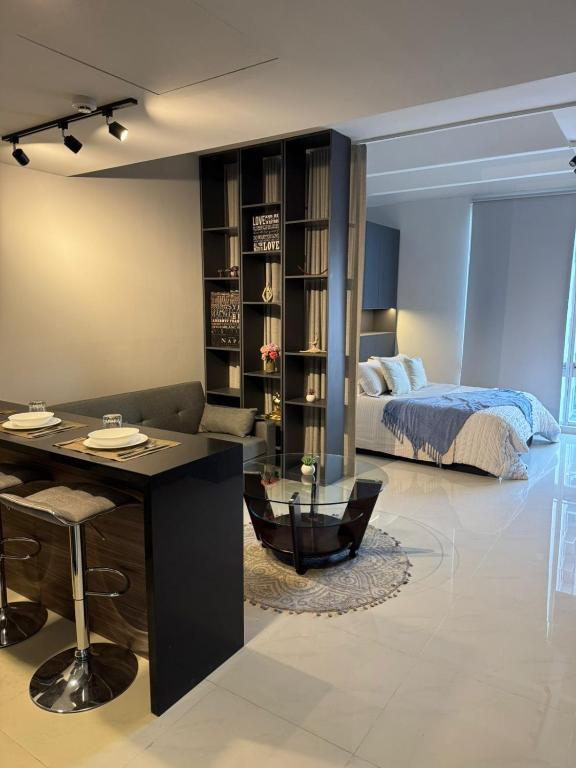 a living room with a bed and a desk and a bedroom at Luxury loft for 2 to 4 people in Monterrey